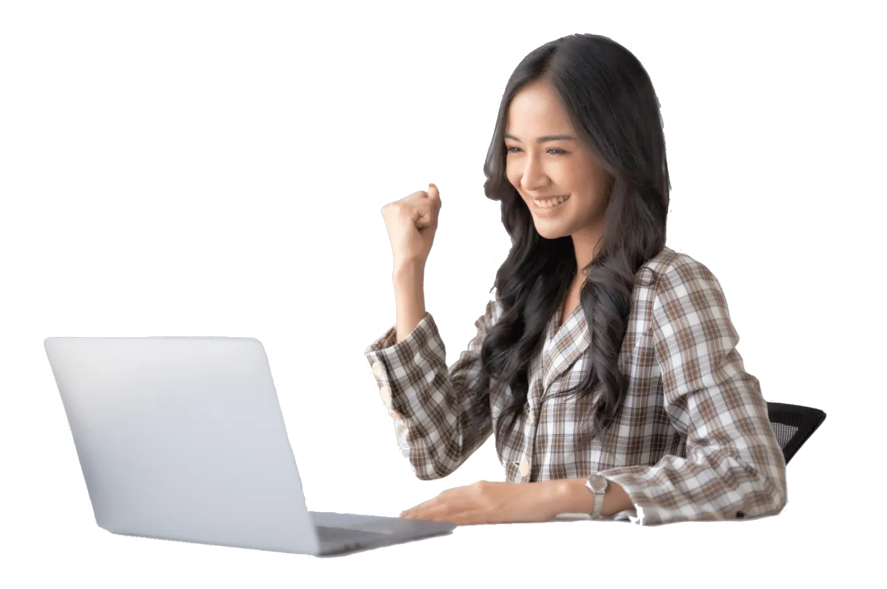 A smiling student celebrating at a laptop